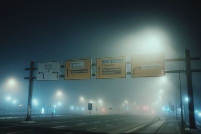 Illuminated road sign at night