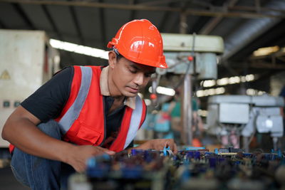 Industrial engineers in hard hats.work at the heavy industry manufacturing factory.