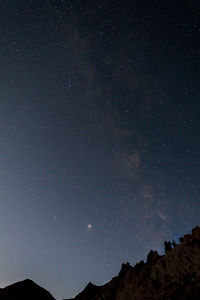 Low angle view of mountain against sky at night