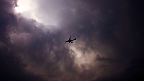 Low angle view of airplane flying in sky