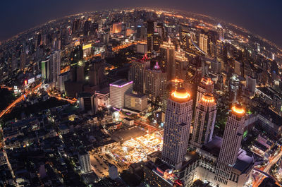 High angle view of illuminated modern buildings in city at night