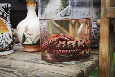 Close-up of water and alcohol in glass on table