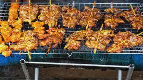 High angle view of meat on barbecue grill