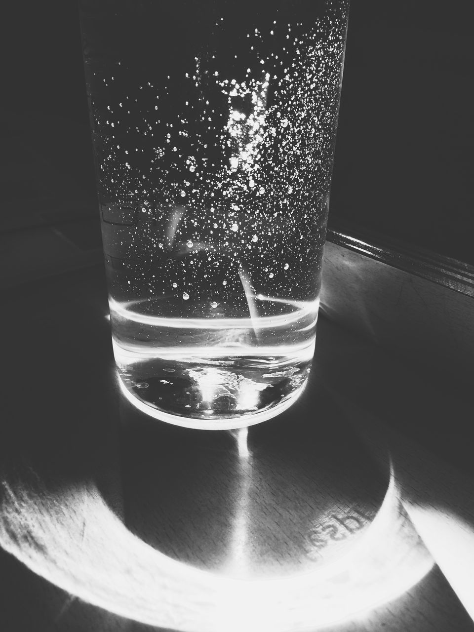drinking glass, drink, water, refreshment, close-up, purity, drinking water, indoors, no people, fragility, black background, illuminated, refraction, tonic water, freshness, day