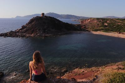 Rear view of woman looking at sea shore