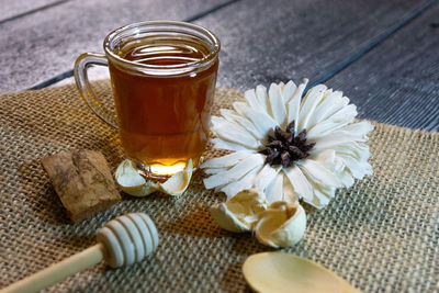 High angle view of glass of white rose on table