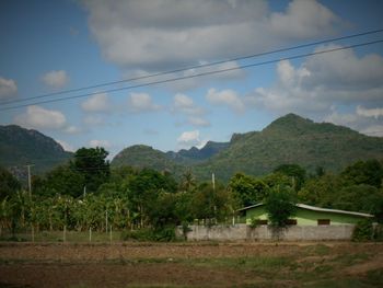Scenic view of mountains against cloudy sky