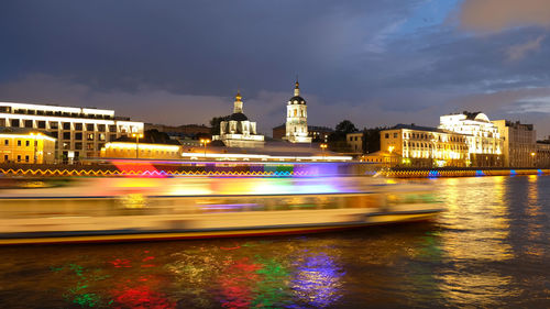 River cruise ship sails along the moscow river, night city, movement by incorporating a motion blur.