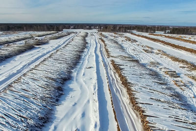 Snow covered land against sky