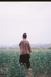 Rear view of man looking at field