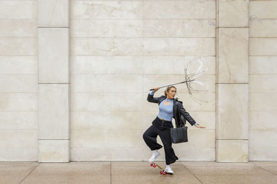 Full length of woman against wall