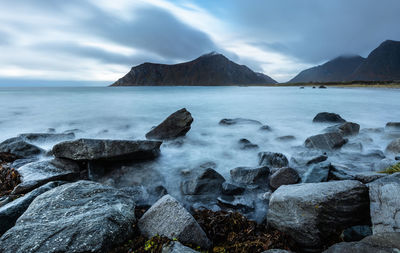 Scenic view of sea and mountain against clear sky