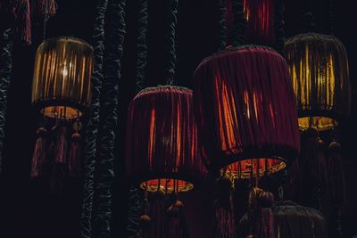 Illuminated lanterns hanging in market for sale