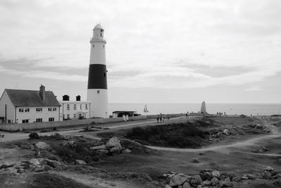 Lighthouse on shore against sky