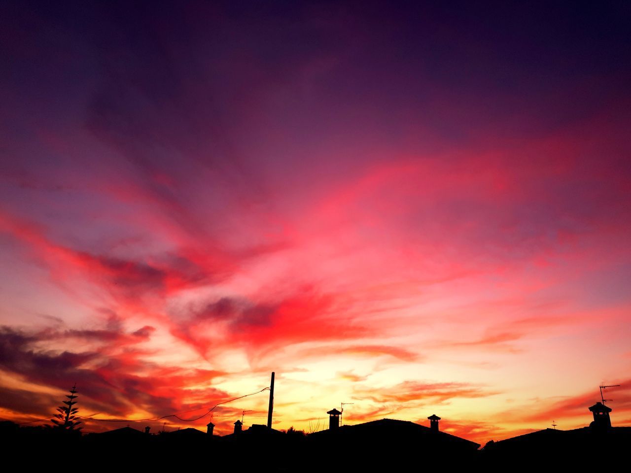 LOW ANGLE VIEW OF DRAMATIC SKY OVER SILHOUETTE LANDSCAPE