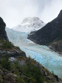 Scenic view of river and mountains against sky