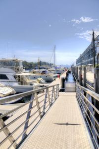 Suspension bridge over sea against clear sky