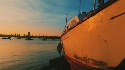 Boat in sea at sunset