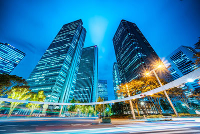 Low angle view of illuminated buildings against sky at night