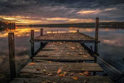 Pier over sea against sky during sunset