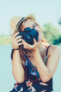 Close-up of woman photographing with camera