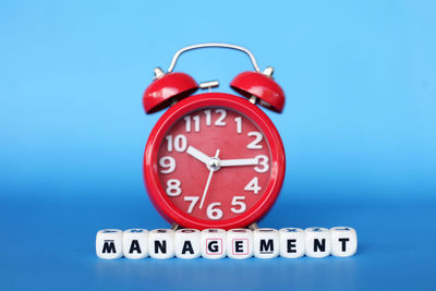 Close-up of clock against blue background
