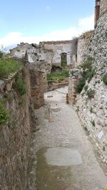 Stone wall of historic building against sky