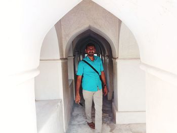 Full length of man walking in corridor on historic building