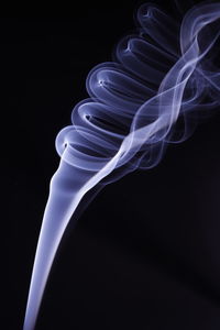 Close-up of illuminated lighting equipment against black background