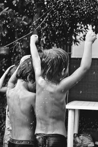 Rear view of shirtless boy in water