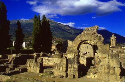 Low angle view of old ruin building against blue sky