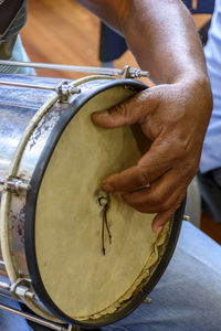 Midsection of man playing drum