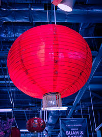 Low angle view of illuminated lanterns hanging at night