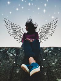 Digital composite image of woman with angel wings against sky