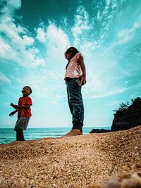 Rear view of women standing on beach