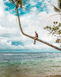 Man standing by sea against sky