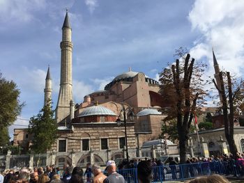 People at mosque against sky