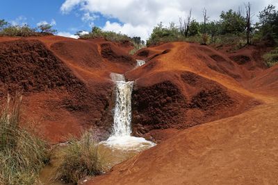 Scenic view of waterfall on mountain