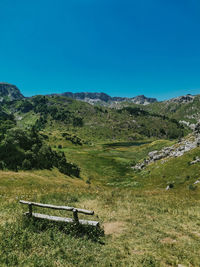 Scenic view of mountains against clear blue sky