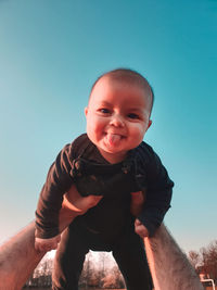 Portrait of cute baby boy against sky