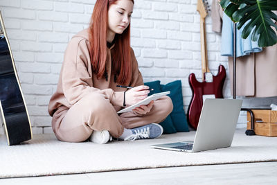 Young woman using laptop at home