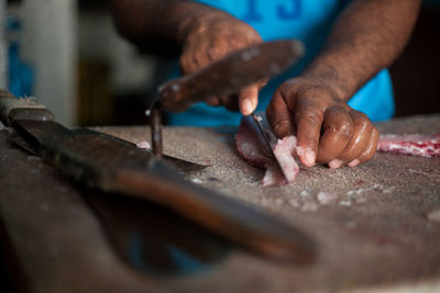 Close-up of butcher cutting meat