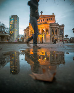 Reflection of buildings in puddle