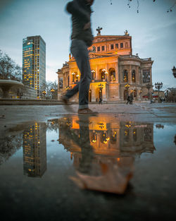 Reflection of building in puddle in frankfurt, germany 