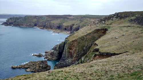 Scenic view of sea and rock formation against sky