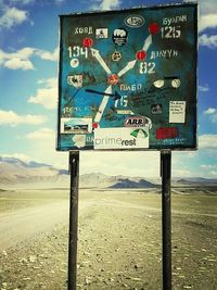 Low angle view of road sign against blue sky