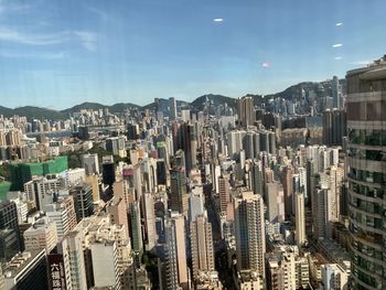 High angle view of modern buildings in city against sky