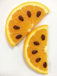 Close-up of orange slices with seeds on table