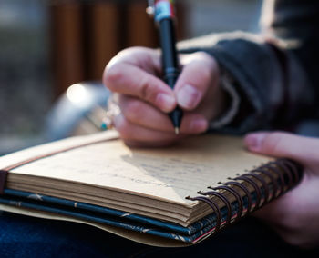 Close-up of hand writing in diary