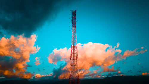 Low angle view of communications tower against blue sky